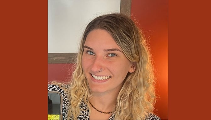 Ivy, Assistant Branch Manager at American Workforce Group, smiling in an office setting.